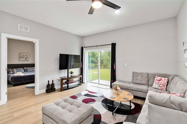 9417 Agate St, Port Charlotte, FL 33981 - living room featuring light wood-style floors, a ceiling fan, and baseboards