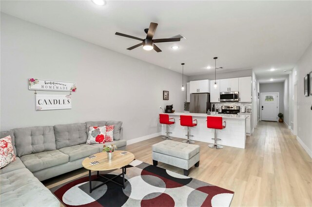9417 Agate St, Port Charlotte, FL 33981 - living room featuring light wood-style floors, ceiling fan, baseboards, and recessed lighting