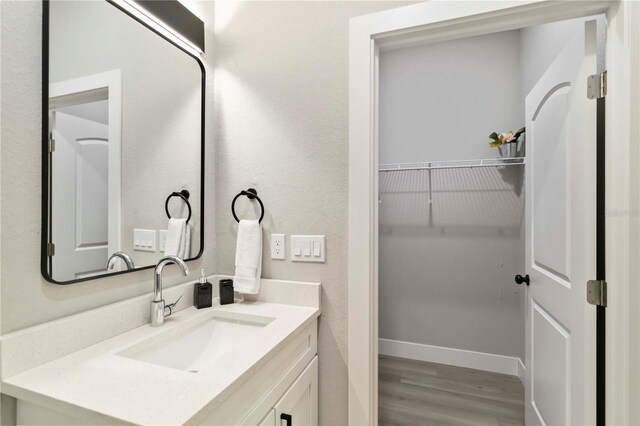 9417 Agate St, Port Charlotte, FL 33981 - bathroom with vanity, wood finished floors, and baseboards