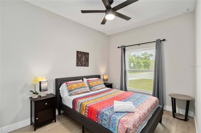 9417 Agate St, Port Charlotte, FL 33981 - bedroom with light wood-style flooring, baseboards, and a ceiling fan