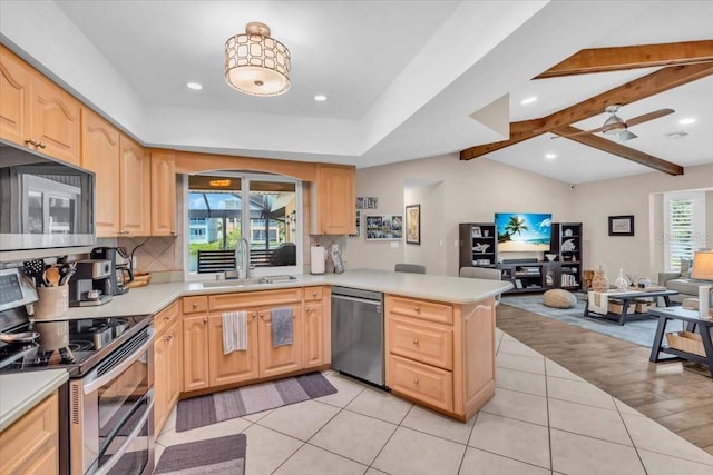 1461 Marlin St, Nokomis, FL 34275 - kitchen featuring stainless steel appliances, light brown cabinetry, open floor plan, backsplash, and recessed lighting