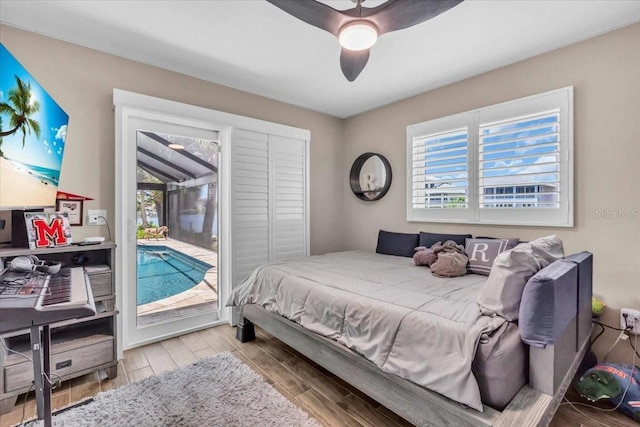 1461 Marlin St, Nokomis, FL 34275 - bedroom featuring access to exterior, multiple windows, wood finished floors, and ceiling fan
