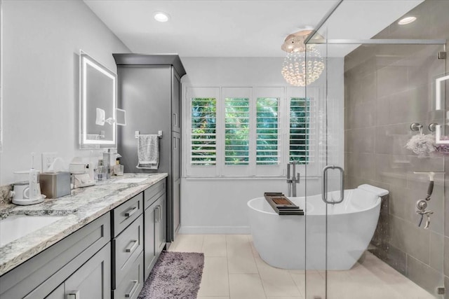 1461 Marlin St, Nokomis, FL 34275 - full bathroom with double vanity, a soaking tub, a stall shower, tile patterned flooring, and recessed lighting