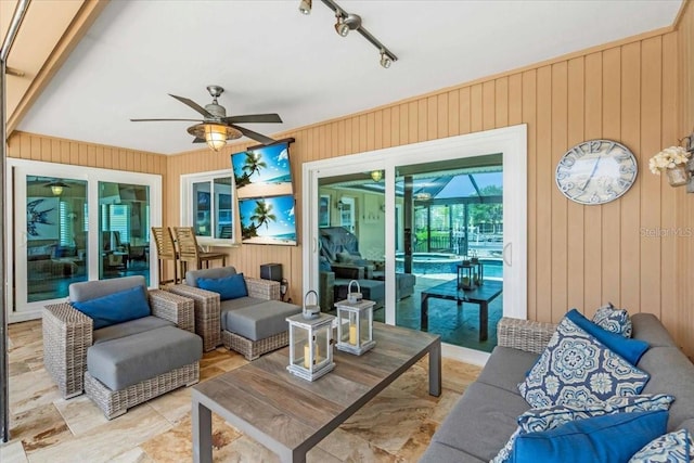 1461 Marlin St, Nokomis, FL 34275 - living room with ceiling fan and wood walls