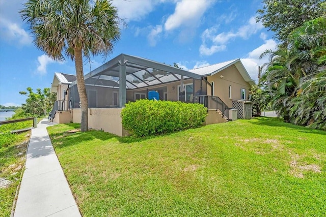 1461 Marlin St, Nokomis, FL 34275 - view of side of property with stucco siding, a lawn, and a lanai