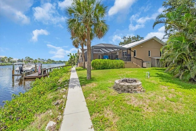1461 Marlin St, Nokomis, FL 34275 - dock area with a water view, a lawn, an outdoor fire pit, and boat lift
