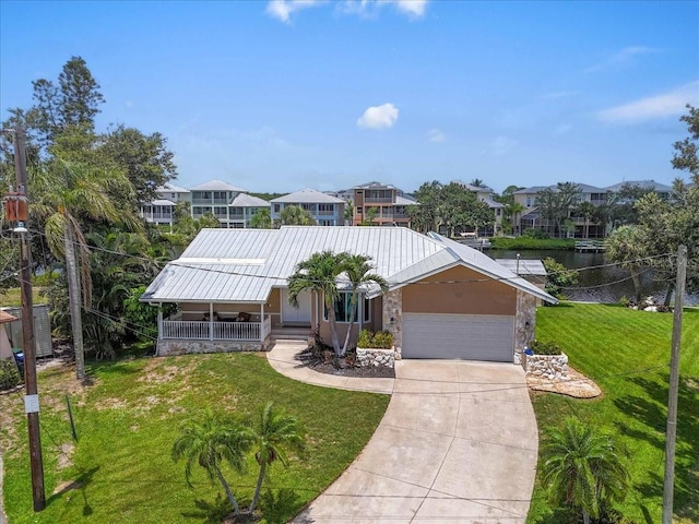1461 Marlin St, Nokomis, FL 34275 - view of front facade with an attached garage, covered porch, a front lawn, a residential view, and a metal roof