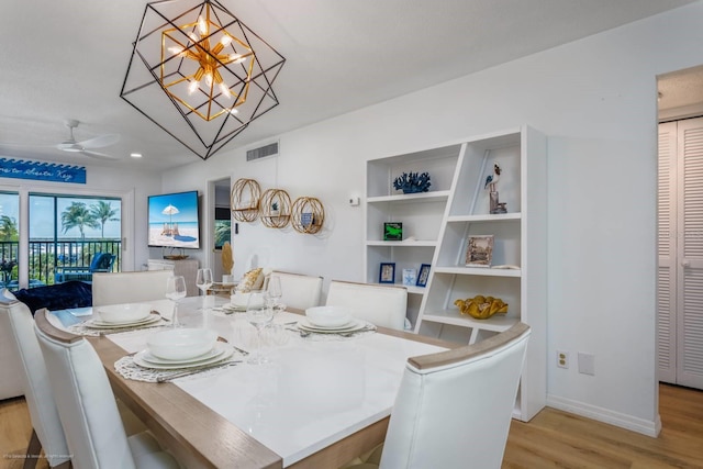 5600 Beach Way Dr Unit 315, Sarasota, FL 34242 - dining area with wood finished floors, a ceiling fan, baseboards, and a chandelier