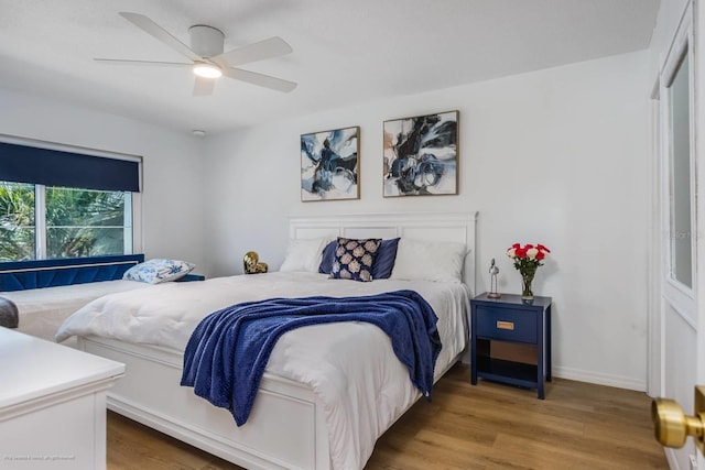 5600 Beach Way Dr Unit 315, Sarasota, FL 34242 - bedroom featuring wood finished floors and ceiling fan