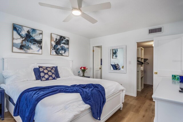 5600 Beach Way Dr Unit 315, Sarasota, FL 34242 - bedroom with light wood-style flooring, a ceiling fan, and baseboards