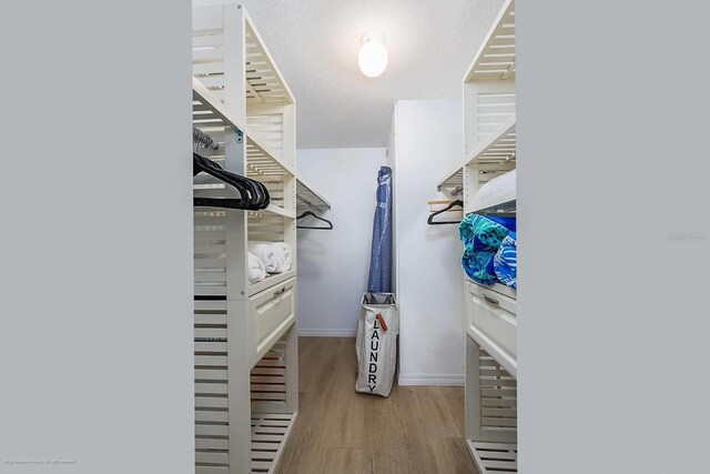 5600 Beach Way Dr Unit 315, Sarasota, FL 34242 - walk in closet with wood finished floors