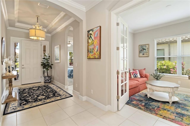 4540 Terrazza Ct, Bradenton, FL 34211 - entryway featuring ornamental molding, a chandelier, arched walkways, and tile patterned floors