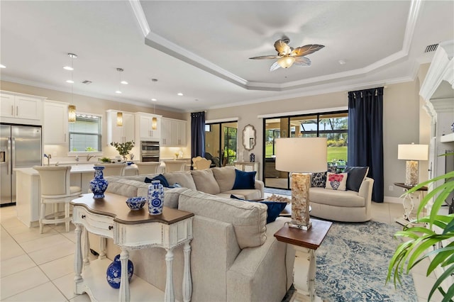 4540 Terrazza Ct, Bradenton, FL 34211 - living room with light tile patterned floors, a ceiling fan, a raised ceiling, ornamental molding, and recessed lighting