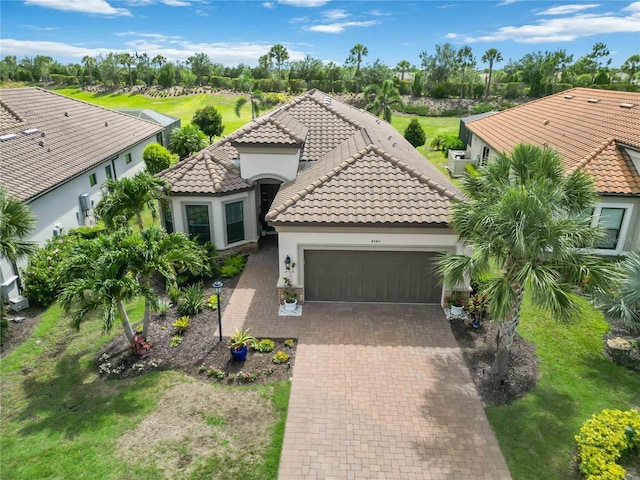 4540 Terrazza Ct, Bradenton, FL 34211 - view of front of home featuring a garage, stucco siding, a tiled roof, and decorative driveway