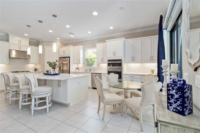4540 Terrazza Ct, Bradenton, FL 34211 - kitchen featuring under cabinet range hood, appliances with stainless steel finishes, crown molding, light countertops, and light tile patterned flooring