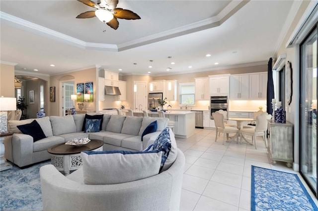 4540 Terrazza Ct, Bradenton, FL 34211 - living room with ceiling fan, a tray ceiling, light tile patterned floors, recessed lighting, and ornamental molding