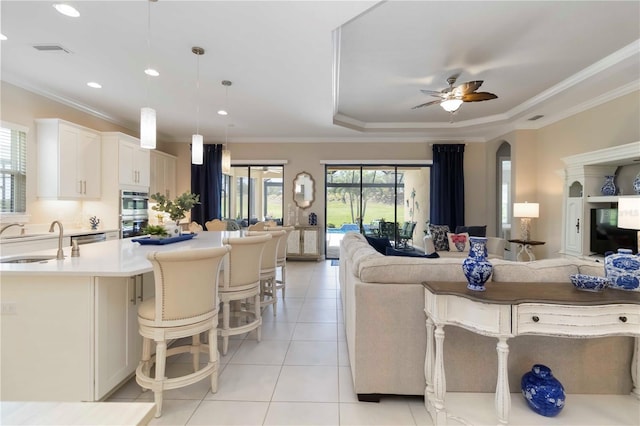 4540 Terrazza Ct, Bradenton, FL 34211 - living area featuring light tile patterned floors, ceiling fan, crown molding, arched walkways, and recessed lighting