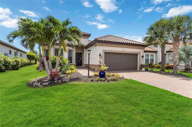 4540 Terrazza Ct, Bradenton, FL 34211 - mediterranean / spanish house featuring stucco siding, an attached garage, a front lawn, decorative driveway, and a tiled roof