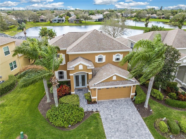 3671 Summerwind Cir, Bradenton, FL 34209 - view of front of property featuring french doors, stucco siding, a water view, and an attached garage