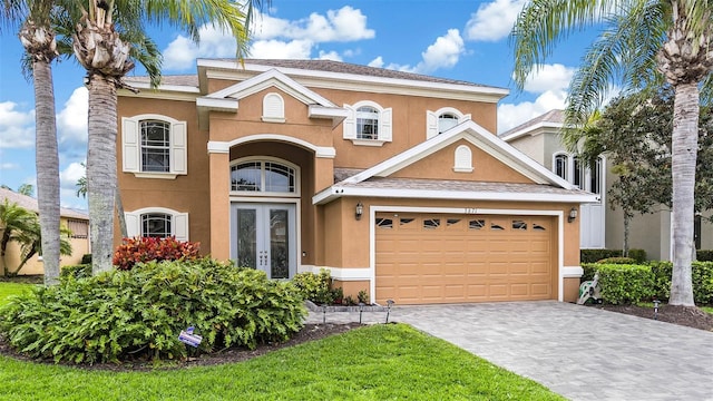 3671 Summerwind Cir, Bradenton, FL 34209 - view of front of home featuring french doors, stucco siding, and decorative driveway