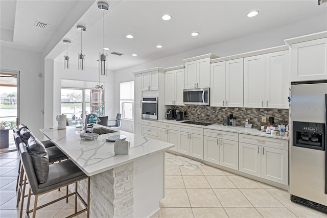 3671 Summerwind Cir, Bradenton, FL 34209 - kitchen with stainless steel appliances, a sink, backsplash, recessed lighting, and white cabinetry