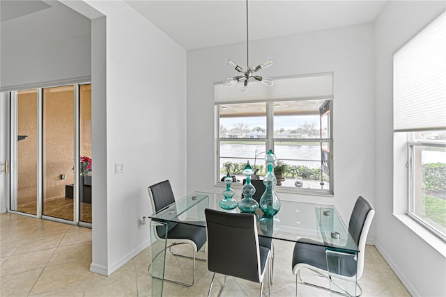 3671 Summerwind Cir, Bradenton, FL 34209 - dining room with a chandelier, tile patterned flooring, a water view, and baseboards