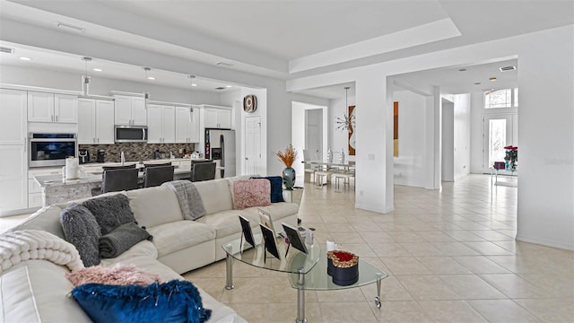 3671 Summerwind Cir, Bradenton, FL 34209 - living room featuring light tile patterned flooring, baseboards, and recessed lighting