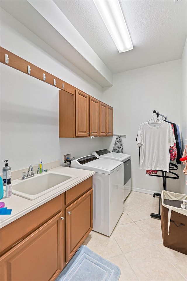 3671 Summerwind Cir, Bradenton, FL 34209 - washroom with cabinet space, washing machine and dryer, light tile patterned flooring, and a textured ceiling