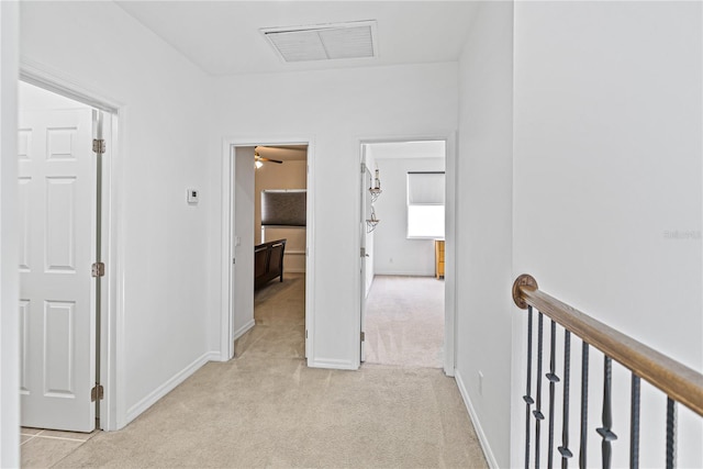 3671 Summerwind Cir, Bradenton, FL 34209 - hall with light carpet, an upstairs landing, and baseboards
