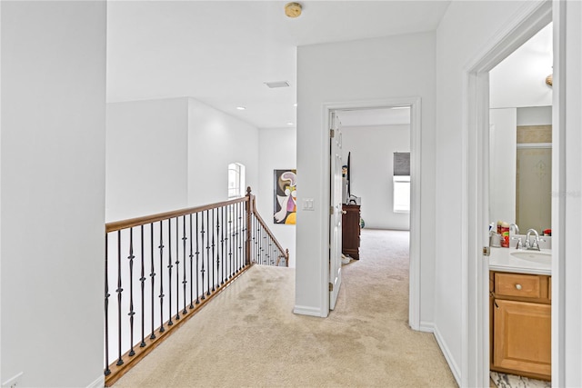 3671 Summerwind Cir, Bradenton, FL 34209 - corridor featuring an upstairs landing, light carpet, and a sink
