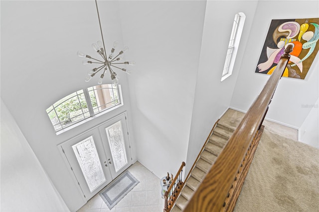 3671 Summerwind Cir, Bradenton, FL 34209 - foyer featuring a high ceiling, stairs, a chandelier, and light tile patterned floors