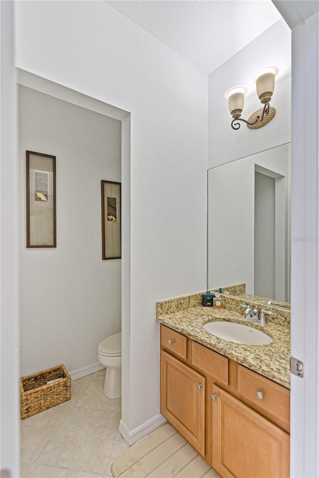 3671 Summerwind Cir, Bradenton, FL 34209 - bathroom featuring toilet, vanity, baseboards, and tile patterned flooring