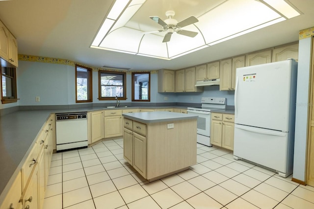 3804 65th St E, Bradenton, FL 34208 - kitchen with white appliances, a ceiling fan, under cabinet range hood, and light tile patterned floors