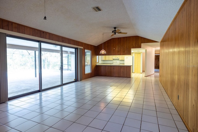 3804 65th St E, Bradenton, FL 34208 - kitchen with wooden walls, vaulted ceiling, a peninsula, a ceiling fan, and under cabinet range hood
