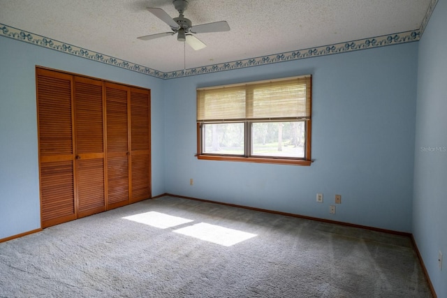3804 65th St E, Bradenton, FL 34208 - unfurnished bedroom with carpet floors, a closet, a textured ceiling, and ceiling fan