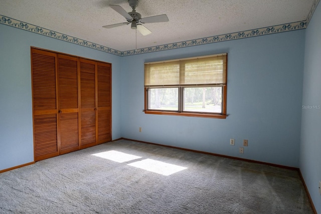 3804 65th St E, Bradenton, FL 34208 - unfurnished bedroom featuring carpet flooring, a closet, a textured ceiling, and a ceiling fan
