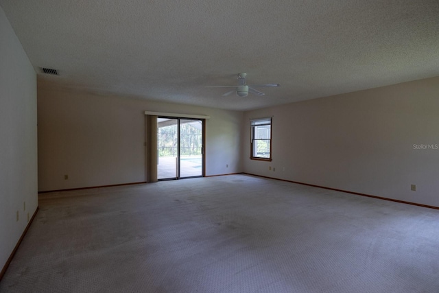 3804 65th St E, Bradenton, FL 34208 - empty room featuring light carpet, ceiling fan, and a textured ceiling