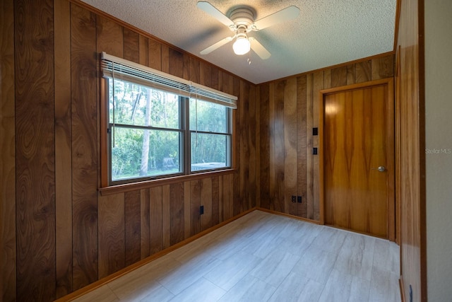 3804 65th St E, Bradenton, FL 34208 - spare room with a textured ceiling, wood walls, and a ceiling fan