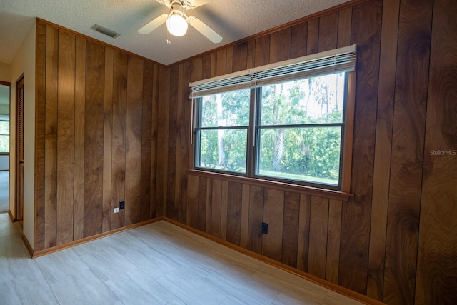 3804 65th St E, Bradenton, FL 34208 - spare room featuring wooden walls, a textured ceiling, and a ceiling fan