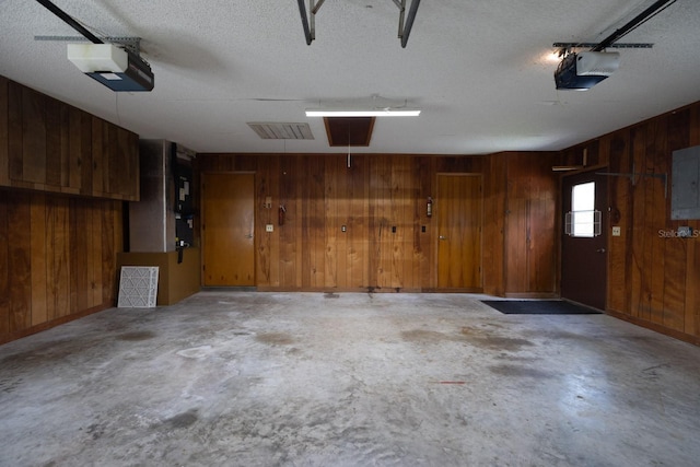 3804 65th St E, Bradenton, FL 34208 - garage with wood walls, a garage door opener, and electric panel