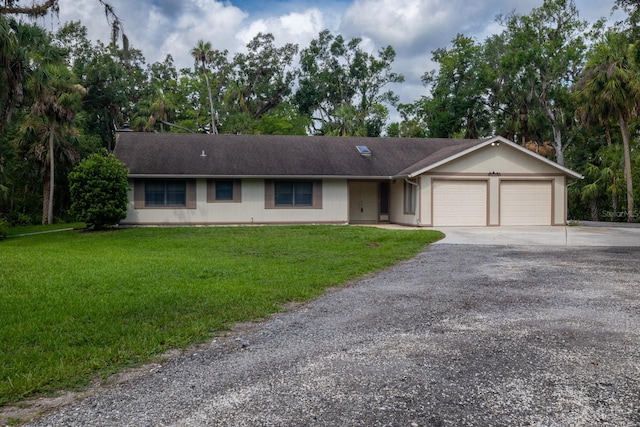 3804 65th St E, Bradenton, FL 34208 - single story home with an attached garage, concrete driveway, and a front lawn