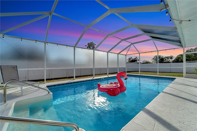 912 Ponderosa Pine Ln, Sarasota, FL 34243 - pool at dusk featuring a patio and a lanai