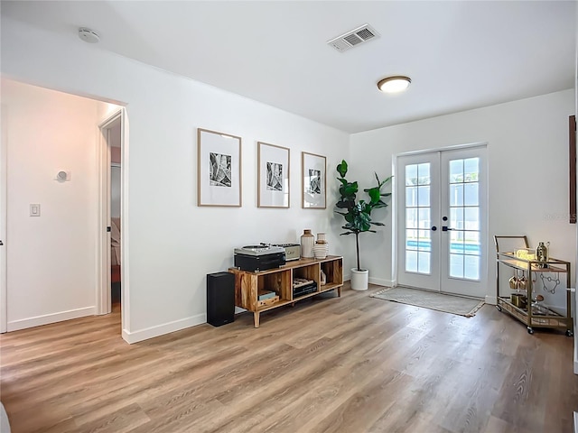 912 Ponderosa Pine Ln, Sarasota, FL 34243 - doorway to outside with french doors and light wood finished floors