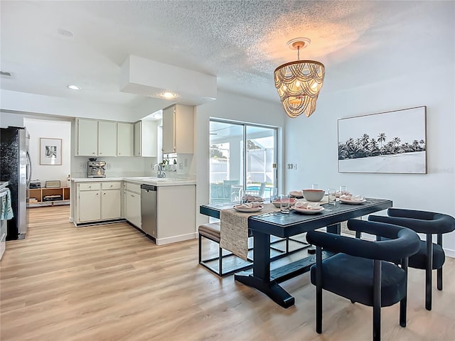 912 Ponderosa Pine Ln, Sarasota, FL 34243 - dining area with light wood finished floors, a chandelier, a textured ceiling, and recessed lighting
