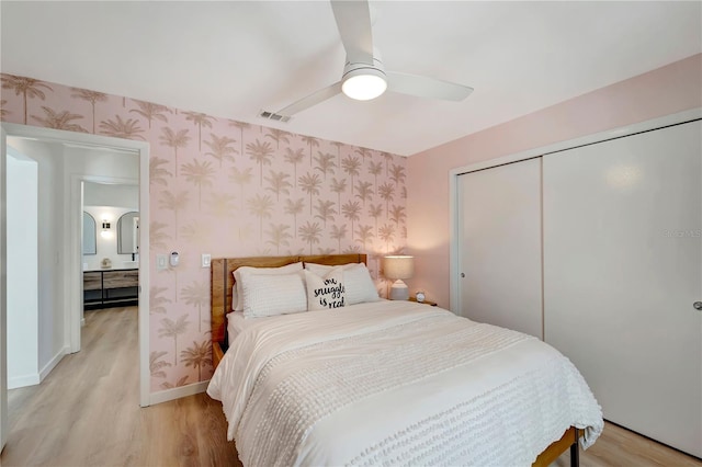 912 Ponderosa Pine Ln, Sarasota, FL 34243 - bedroom with wallpapered walls, light wood-type flooring, a closet, and a ceiling fan