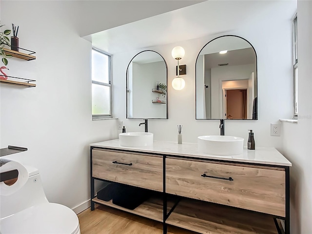 912 Ponderosa Pine Ln, Sarasota, FL 34243 - bathroom featuring wood finished floors and double vanity