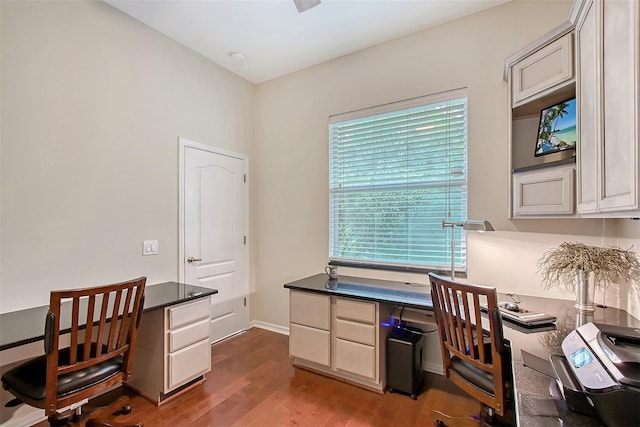 7464 Ridge Rd, Sarasota, FL 34238 - home office featuring dark wood finished floors and built in study area