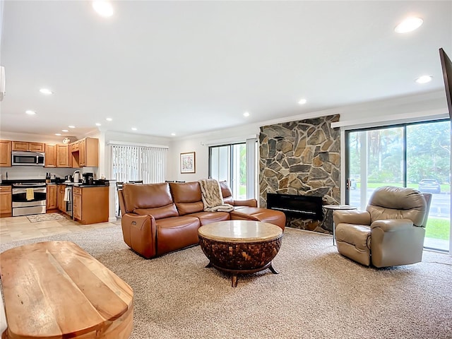 2220 Bahia Vista St Unit G4, Sarasota, FL 34239 - living area featuring crown molding, recessed lighting, a fireplace, and light carpet
