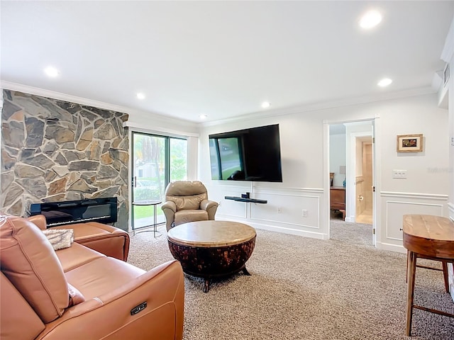 2220 Bahia Vista St Unit G4, Sarasota, FL 34239 - carpeted living room featuring crown molding, a stone fireplace, a wainscoted wall, and recessed lighting