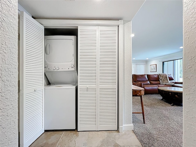 2220 Bahia Vista St Unit G4, Sarasota, FL 34239 - laundry area with stacked washer / drying machine and a textured wall